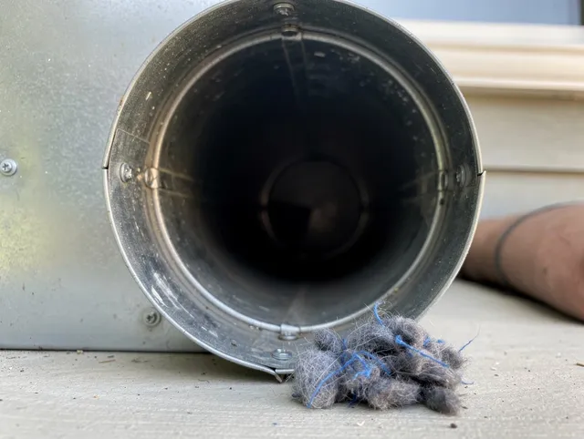 Norwalk Dryer Vent Cleaning technician using specialized equipment to clear severe dryer vent blockage in Norwalk